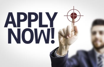 Business man pointing to transparent board with text: Apply Now!