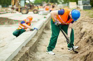Horizontal image of two builders working hard
