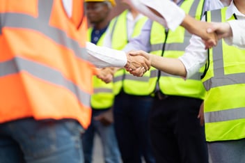 Team shaking hand on job site