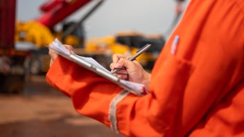Foreman checking on safety checklist form at jobsite