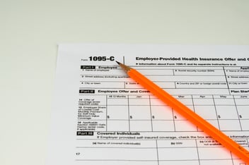 Tax Form 1095-C with pencil