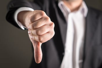 Businessman showing thumbs down